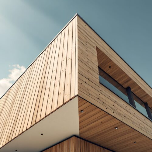 Modern architectural building with natural wood facade and geometric patterned cladding against a bright blue sky with scattered clouds